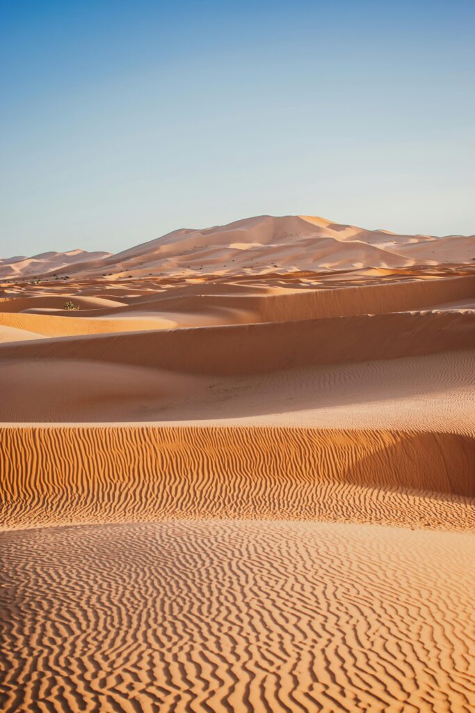 pexels-photo-19190939-19190939 Captivating view of the vast sand dunes in the Merzouga Desert, Morocco, under a clear blue sky.