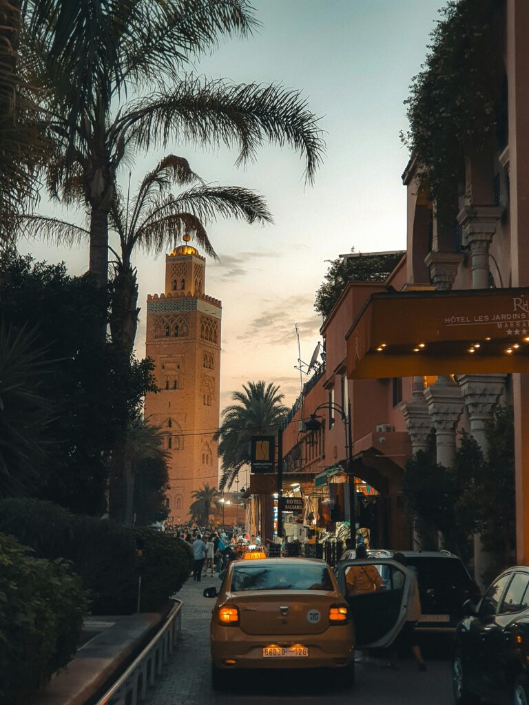 pexels-photo-30682505-30682505 Explore the vibrant Marrakech streets at sunset, featuring iconic minaret and lively atmosphere.