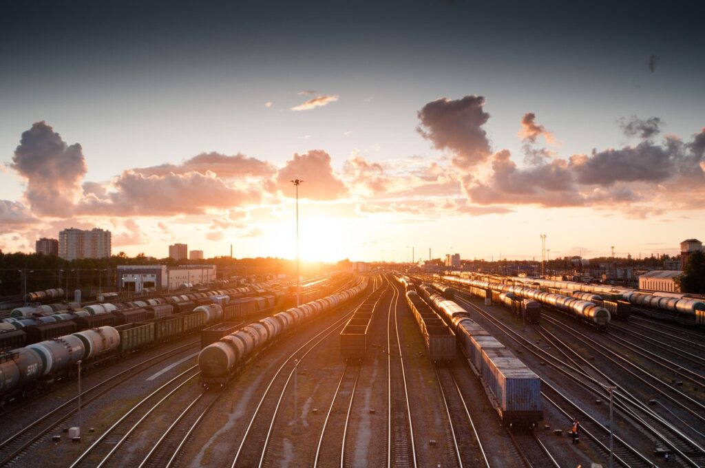 train, sunset, tracks, railroad, transportation, transport, travel, station, railway, rail, industry, nature, platform, locomotive, traffic, technology, sky, carriage, city, speed, departure, industrial, dusk, wagon, light, transit, modern, urban, street, business, delivery, subway, steel, perspective, motion, building, passenger, journey, logistic