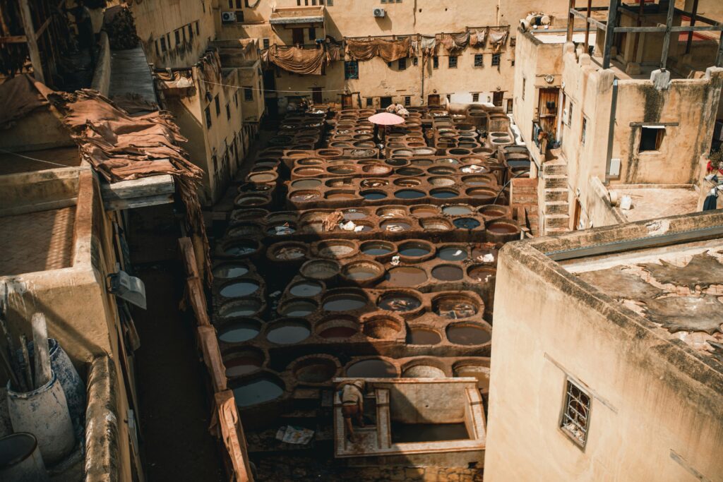 Explore the iconic Chouara Tannery in Fes, Morocco, showcasing traditional leather tanning methods from above.
